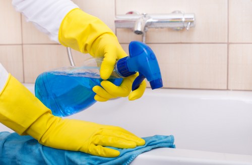 Technician performing upholstery cleaning in Acton on a living room sofa