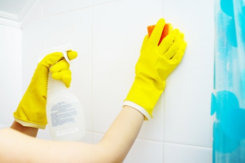 Cleaner wearing PPE while carrying out carpet cleaning in Acton
